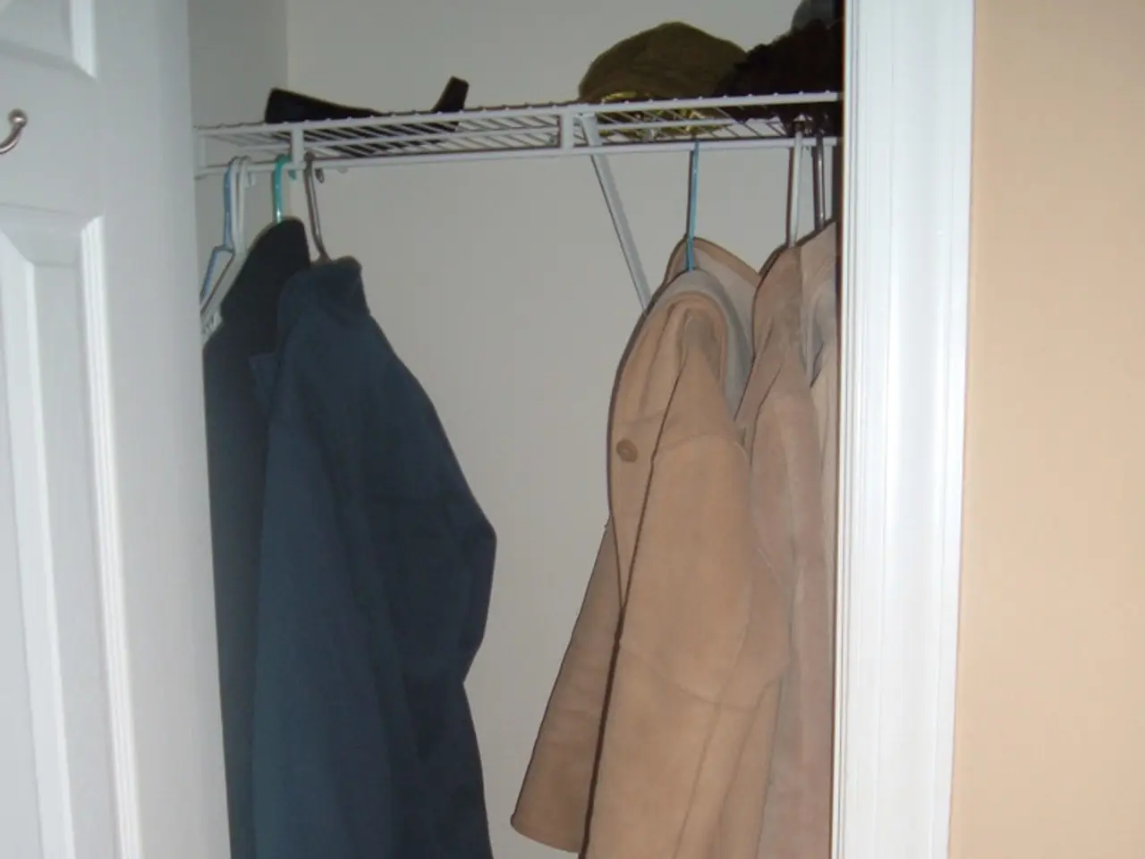 In the image we can see there are shoes and sandals kept on the shoe stand. There is a bag kept on...