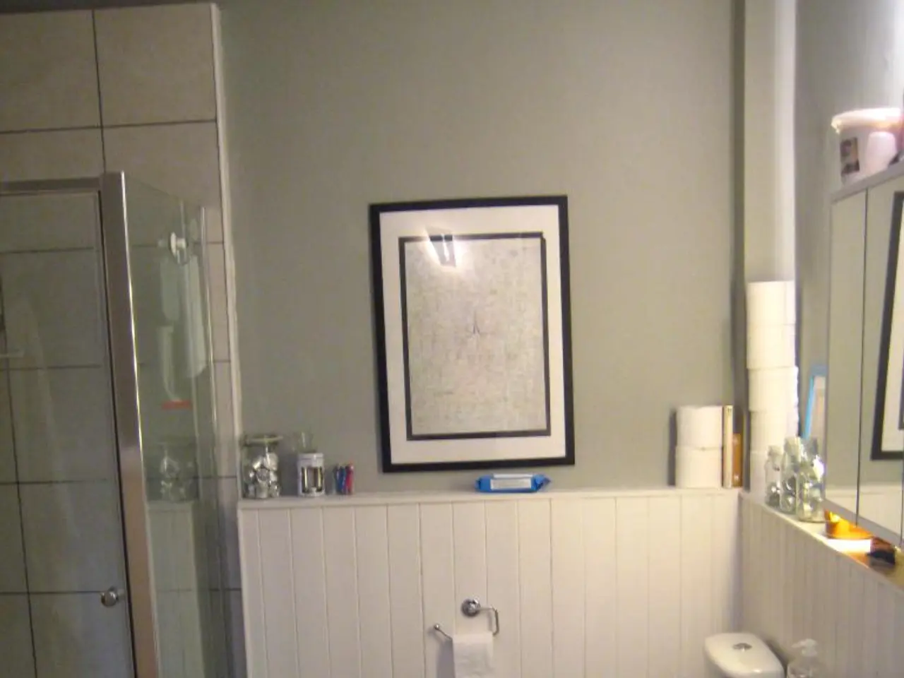 In this image, we can see an inside view of a bathroom. There is a shower cabin on the left side of...