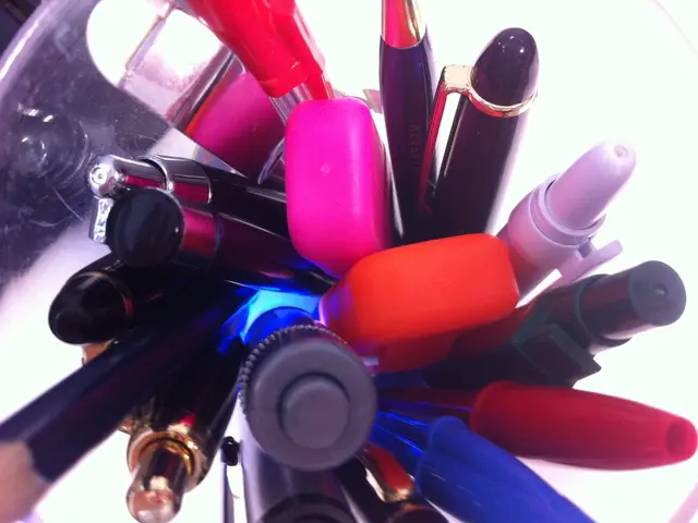 In the center of the image we can see pens, one pencil and a few other objects. At the top left...