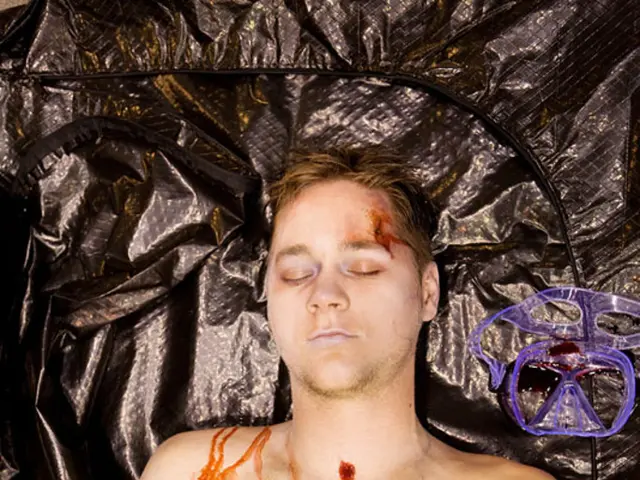 In this picture we can see the dead body of the boy lying on the black plastic cover.