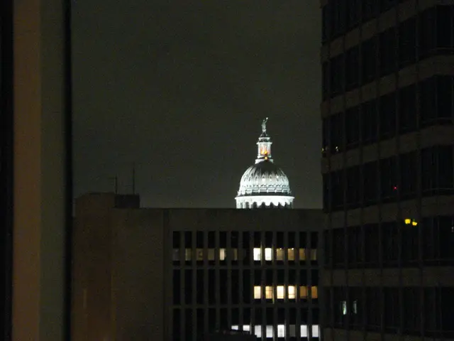 In the picture we can see buildings and there is dark sky.