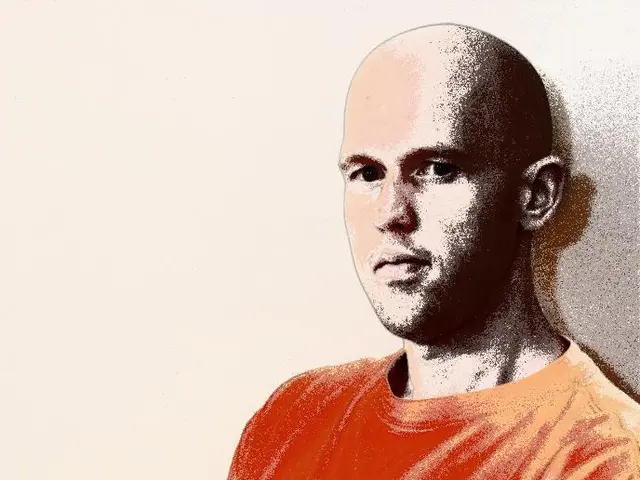 In this image we can see a person wearing orange shirt and black pant with bald head.