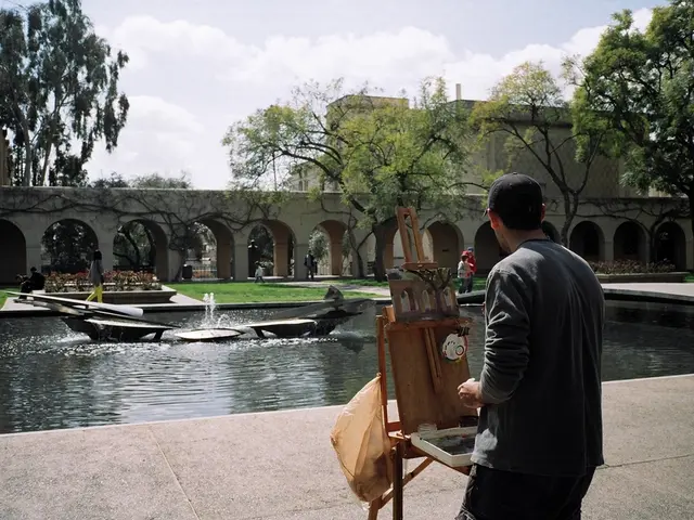 In this image I can see on the right side a man is standing and looking at the waterfall. He wore...