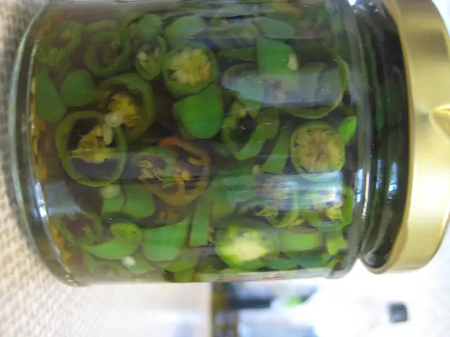 In this picture I can see there is a jar with chilies and they are cut into pieces and there is a...